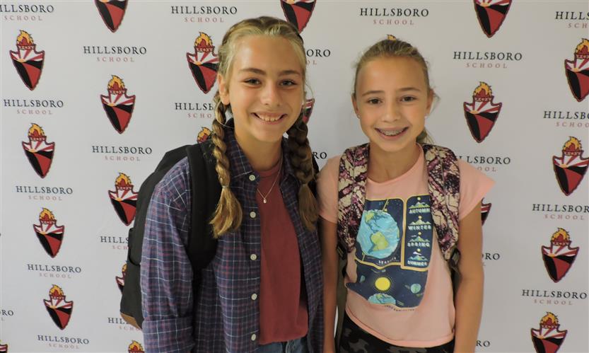 Two students smile